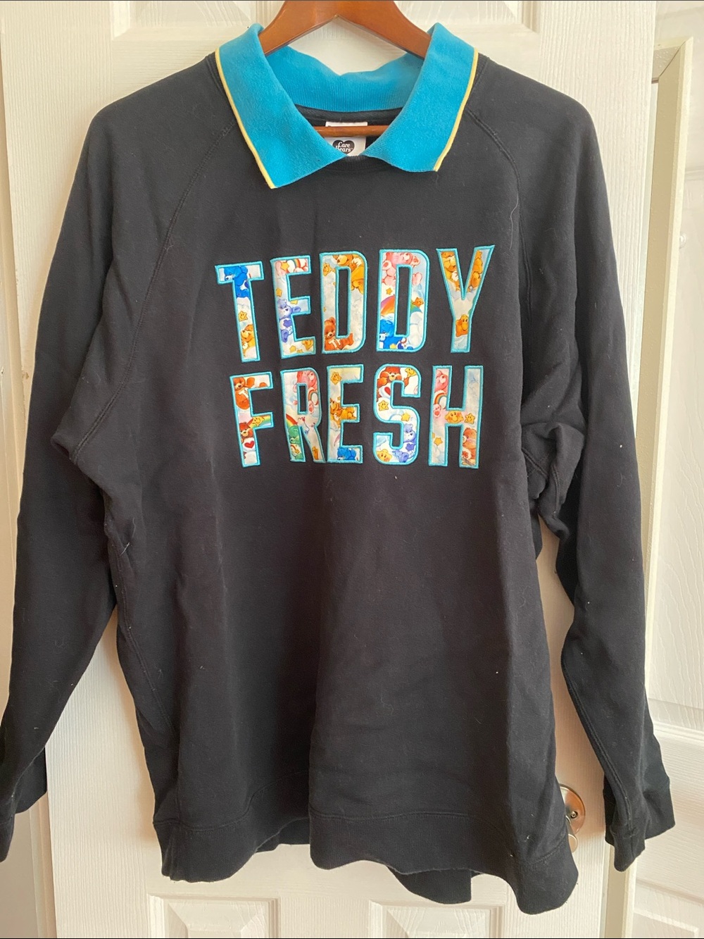 Teddy Fresh Black Sweater with Turquoise Collar and Multicolor Care Bears Logo